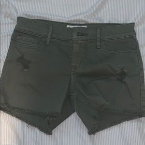Army green denim shorts.